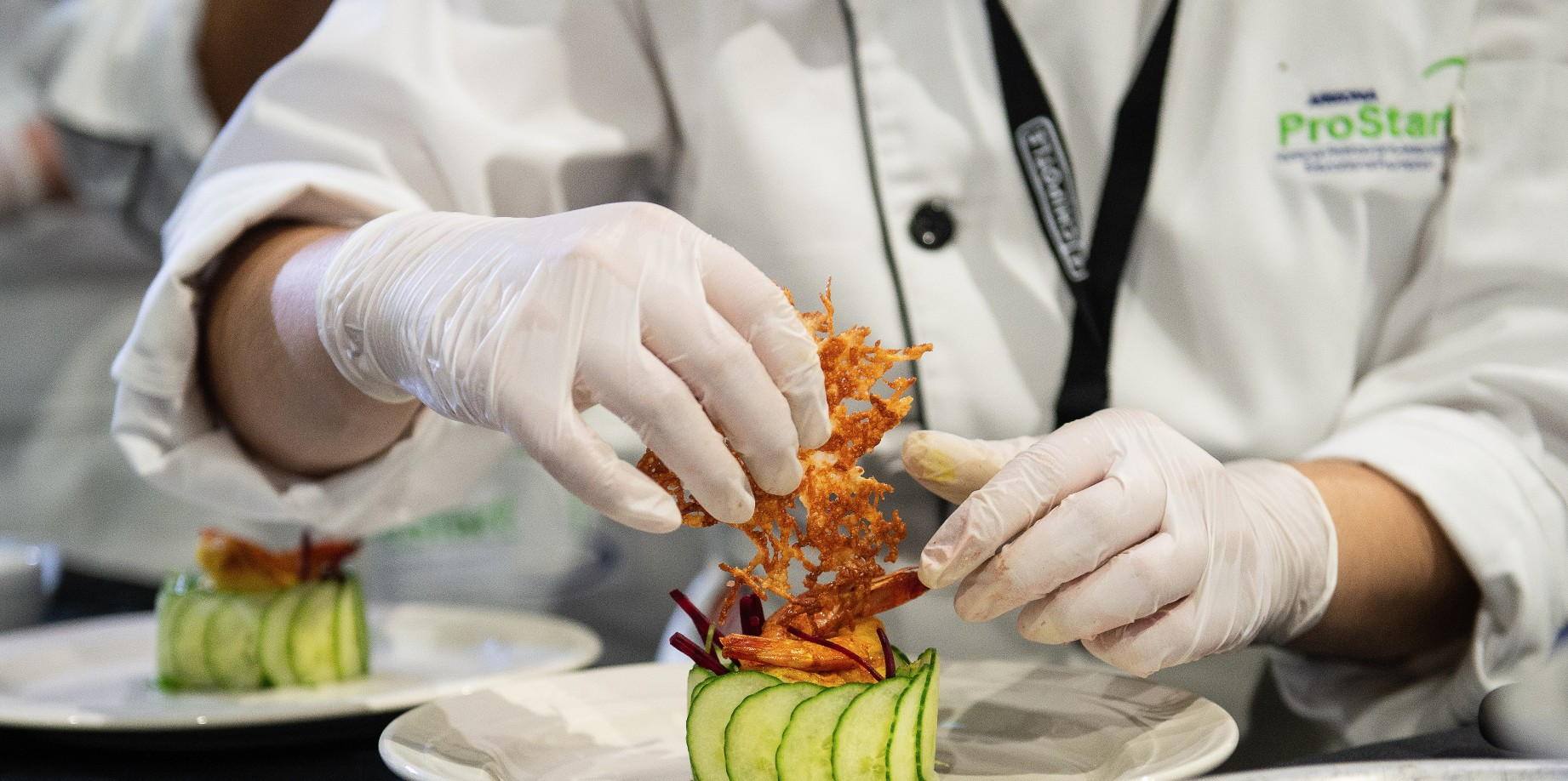 Student putting on final touch to plate of food